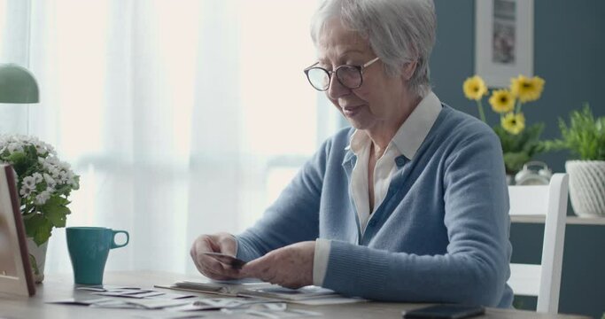 Senior woman looking at old pictures