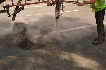 Repair cracks in asphalt with a hot mix of resin and small gravel