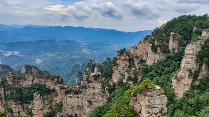 Fototapeta na wymiar The sandstone pillars. Mountains in the national park Wulingyuan. Mountain valley. Trees on rocks. Zhangjiajie. UNESCO World Heritage Site. China. Asia
