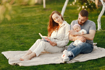 Parents with daughter. Family in a park. Newborn girl.