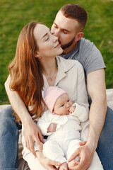 Fototapeta premium Parents with daughter. Family in a park. Newborn girl.
