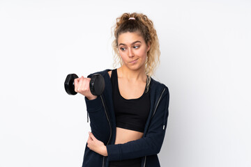 Young sport woman making weightlifting isolated on white background with sad expression