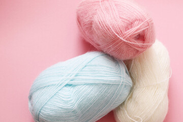 pastel colours yarn balls on pink background