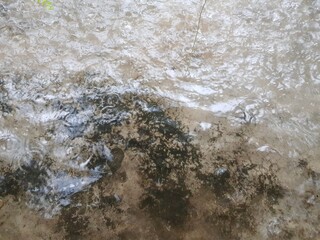 It rains on the cement floor, there is water and a little wave.