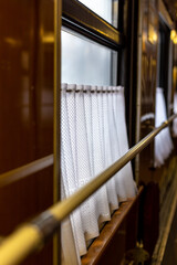 Lace curtains on the window in the train carriage