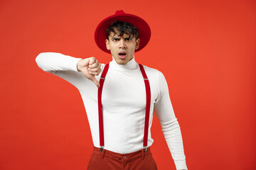 Young spanish latinos indigant displeased dissatisfied bored man 20s wearing casual hat white shirt...