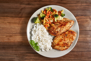 Grilled chicken breast with rice and sauteed veggies