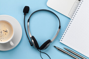 Office desk with headset and laptop. Work from home