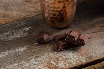 The dessert food vintage style : The Marshmallow with hot chocolate in copper cup on the wooden table. Background copy space for copy text