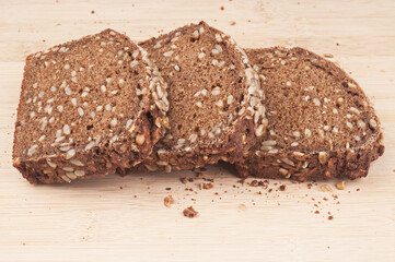 Rye bread slices on wooden cutting-board background