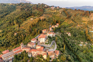 Fototapeta na wymiar Aerial view of the Tuscan village Mommio Castello, at the top of the hill of Versilia, province of Lucca, Italy