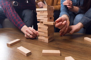 Hands stand a tower of wooden sticks, teamwork concept, team play