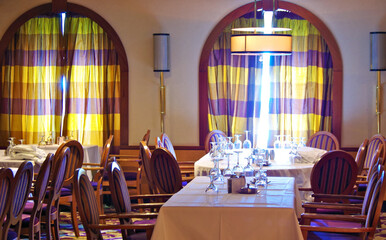 Formal dining room or restaurant with set tables onboard classic cruiseship or cruise ship liner...