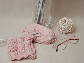 home hobbies, cozy knitted sweaters with a ball of yarn in the living room on a wooden background