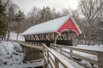 A beautiful red covered bridge in winter