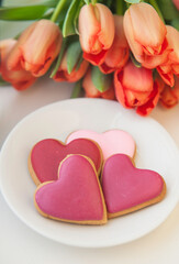 Decorated heart shaped cookies on white background, top view