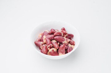 raw chicken hearts on a white plate on a white background. Photo for clipping