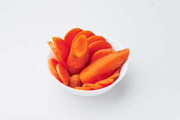 Raw chopped carrots in a white plate on a white background. photo for clipping. Close-up