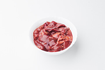 raw chicken liver in a white plate on a white background. Close-up. photo for clipping.
