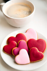 Decorated heart shaped cookies on white background, top view