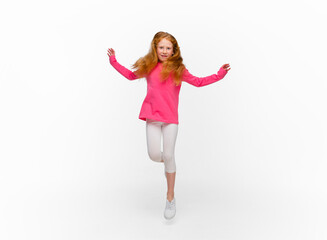 Smiling, jumping high. Happy, smiley redhair girl isolated on white studio background with copyspace for ad. Looks happy, cheerful. Childhood, education, human emotions, facial expression concept.