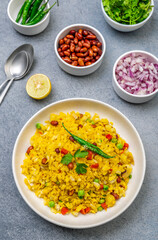 spicy Indian snack or breakfast  poha with onion and peanuts