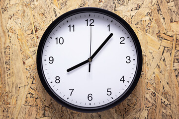 Clock watch at wooden chipboard of wall surface background