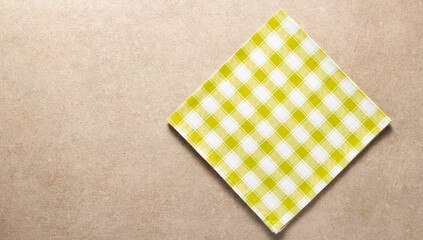 Checked or checkered tablecloth at stone surface of table. Top view of cloth napkin texture background