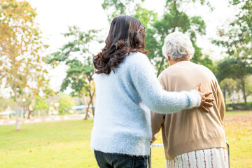 Help and care Asian senior or elderly old lady woman use walker with strong health while walking at...