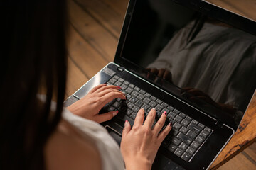 detail of woman's hands using a computer with top view