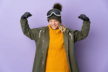 Skier Russian girl with snowboarding glasses isolated on purple background doing strong gesture