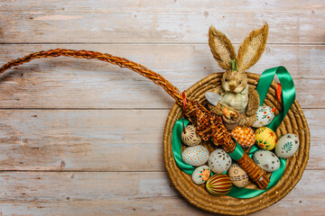 Happy Easter card.Colorful hand painted decorated Easter eggs and bunny.Handmade Easter egg on wooden table copy space.Spring decoration background.Festive tradition for European countries.Funny scene