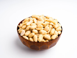 Peanuts in a wooden bowl on white background,Peanuts, plants rich in nutrients and high protein.