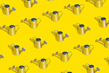 Metal watering can Metal watering can on bright yellow background. Minimal bold color garden pattern. Gardening, growing, spring or summer concept
