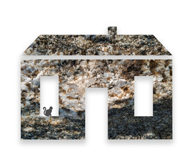 Model of a house made of natural granite. Cat in the window