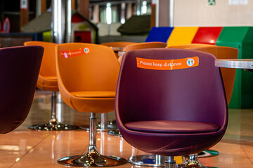 ferry restaurant, empty seats with warning to keep social distance during covid-19 outbreak