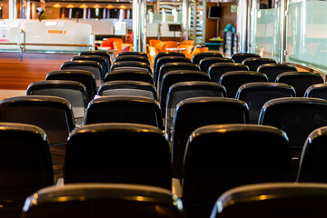 rows of comfortable empty seats awaiting for passengers inside a ferry