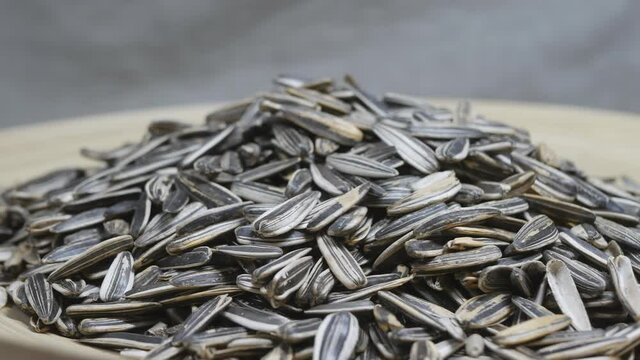 the striped sunflower seeds in the bowl rotate slowly.