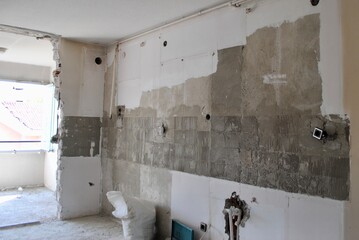 Kitchen wall during reconstruction work without door, tiles and tap. Home renovation improvement. Home repairing.