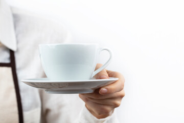 coffee time. A barista holding and presenting a glass of hot coffee isolated on a white background.
