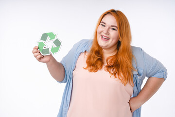 Smiling fat woman holding recycling sign isolated over white background