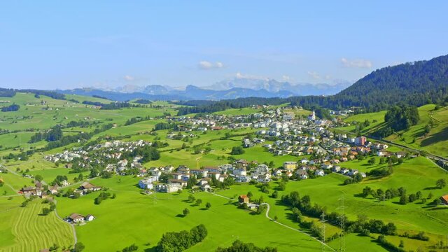 Drone flying to the right over Samstagern in Richterswil, Zurich, Switzerland. An amazing natural landscape in sunny weather
