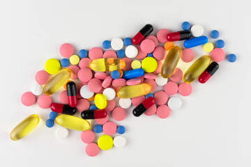 Lots of colored pills on a white background. Top view.