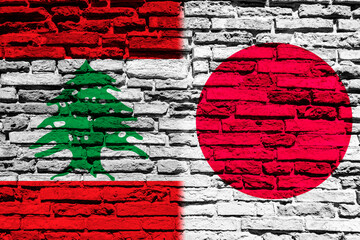 Flag of Lebanon and Japan on brick wall