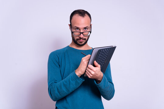 Man Using Ipad Or Tablet On White Background With Glasses With Casual Clothes. Account Or Office Worker