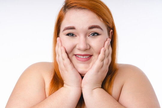 Cropped shot of a young ginger-haired plump woman with healthy skin isolated over white background