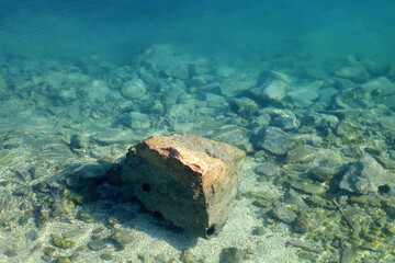 Rock in the shallow sea. Selective focus.
