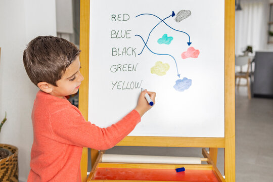 Little boy learning english with his mother at home - Powered by Adobe