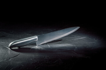 Kitchen knife on dark background with copy space
