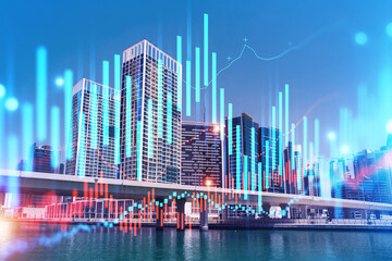 Fototapeta premium Skyscrapers of Dubai business downtown. International hub of trading and financial services of Western Asia. FOREX graph and chart concept. Double exposure. Dubai Canal waterfront.